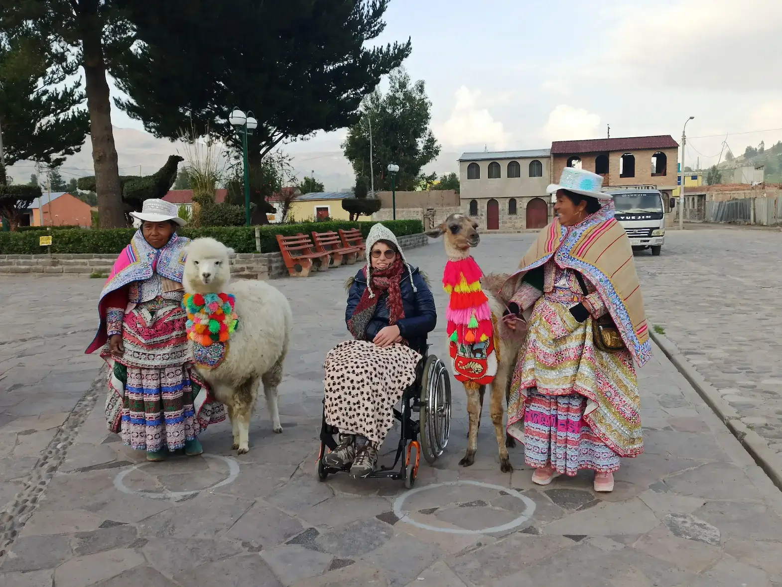wheelchair traveler with alpacas traditional Peruvian women accessible cultural tour Peru